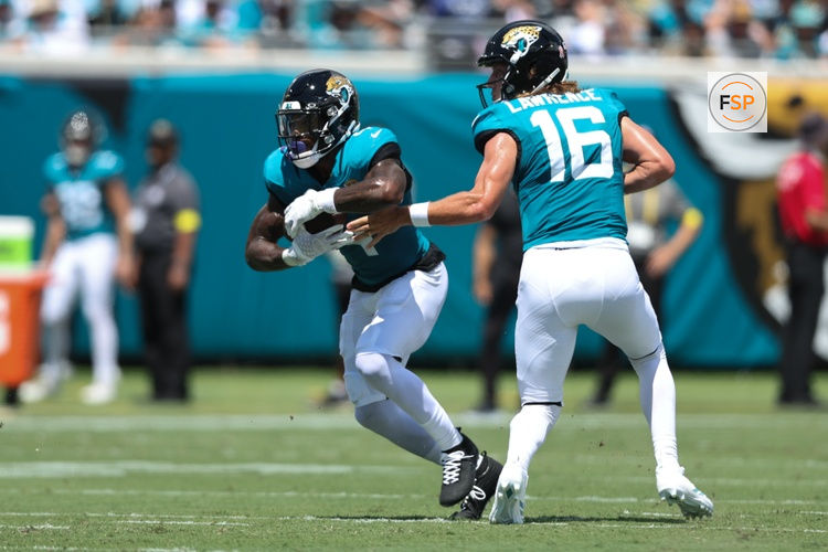 Sep 7, 2025; Jacksonville, Florida, USA; Jacksonville Jaguars quarterback Trevor Lawrence (16) hands off to running back Tank Bigsby (4) against the Carolina Panthers during the first half at EverBank Stadium. Credit: Morgan Tencza-Imagn Images