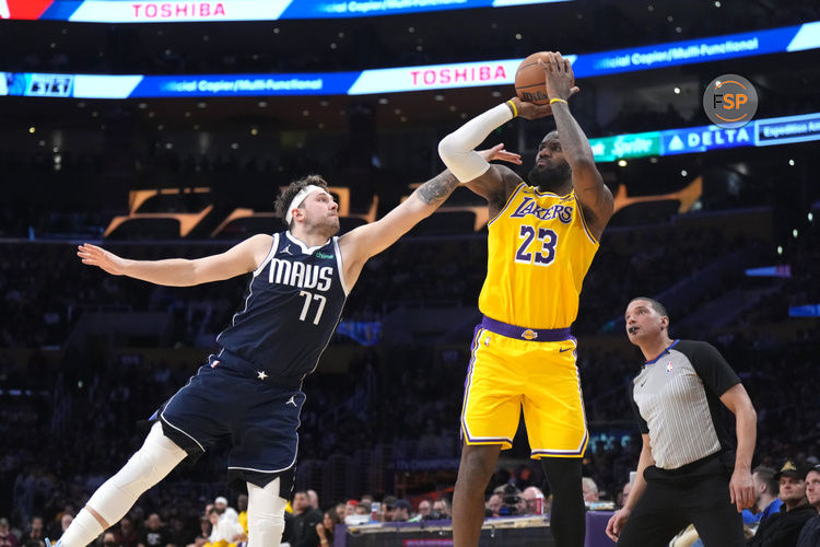 Jan 17, 2024; Los Angeles, California, USA; Los Angeles Lakers forward LeBron James (23) shoots the ball against Dallas Mavericks guard Luka Doncic (77) in the second half at Crypto.com Arena. Credit: Kirby Lee-USA TODAY Sports