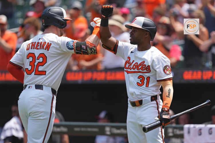 Jul 30, 2025; Baltimore, Maryland, USA; Baltimore Orioles first baseman Ryan O’Hearn (32) greeted by outfielder Cedric Mullins (31) following his two run home run during the first inning against the Toronto Blue Jays at Oriole Park at Camden Yards. Credit: Mitch Stringer-Imagn Images