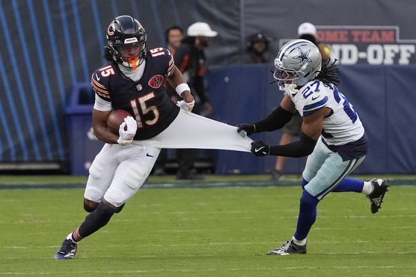 Sep 21, 2025; Chicago, Illinois, USA; Dallas Cowboys defensive back Reddy Steward (27) grabs Chicago Bears wide receiver Rome Odunze (15) jersey during the second half at Soldier Field. Mandatory Credit: David Banks-Imagn Images