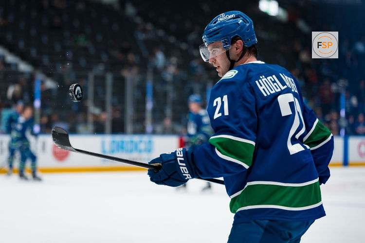 Apr 14, 2026; Vancouver, British Columbia, CAN; Vancouver Canucks forward Nils Hoglander (21) handles the puck in warm up prior to a game against the Los Angeles Kings at Rogers Arena. Credit: Bob Frid-Imagn Images