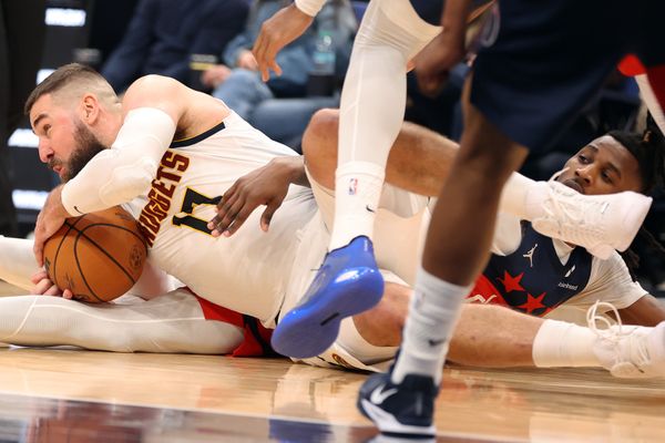 Jan 22, 2026; Washington, District of Columbia, USA; Denver Nuggets center Jonas Valanciunas (17) fights for the ball against Washington Wizards guard Jamir Watkins (5) during the second half at Capital One Arena. Mandatory Credit: Daniel Kucin Jr.-Imagn Images