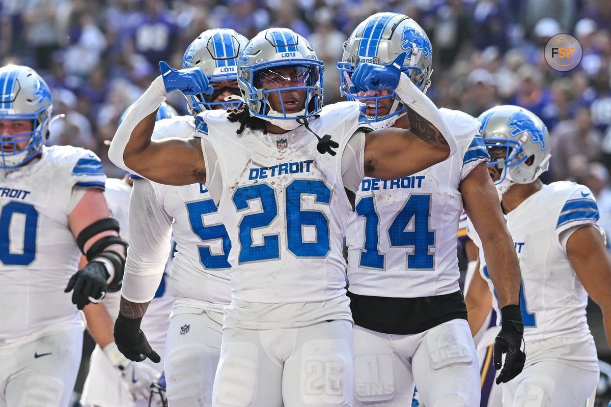 Oct 20, 2024; Minneapolis, Minnesota, USA; Detroit Lions running back Jahmyr Gibbs (26) reacts with wide receiver Amon-Ra St. Brown (14) and offensive tackle Penei Sewell (rear) after running for an 8 yard touchdown during the second quarter against the Minnesota Vikings at U.S. Bank Stadium. Credit: Jeffrey Becker-Imagn Images