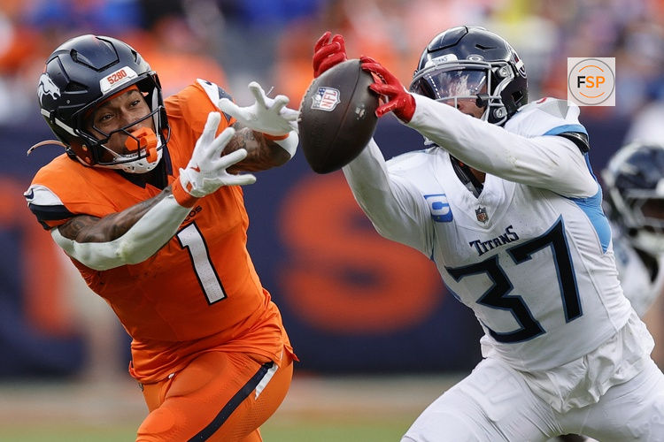 Sep 7, 2025; Denver, Colorado, USA; Tennessee Titans safety Amani Hooker (37) knocks the ball away from Denver Broncos tight end Evan Engram (1) in the first half at Empower Field at Mile High. Credit: Isaiah J. Downing-Imagn Images