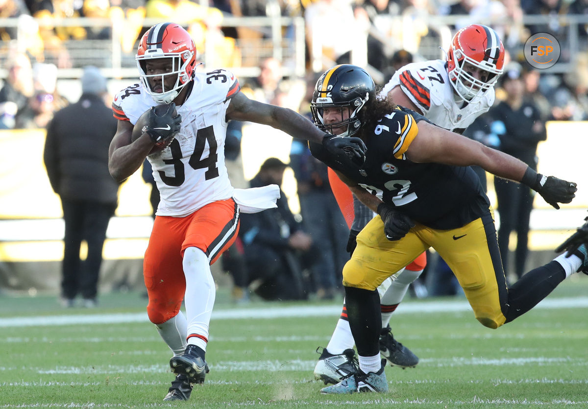 Dec 8, 2024; Pittsburgh, Pennsylvania, USA;  Cleveland Browns running back Jerome Ford (34) runs the ball past Pittsburgh Steelers defensive tackle Isaiahh Loudermilk (92) during the third quarter at Acrisure Stadium. Credit: Charles LeClaire-Imagn Images