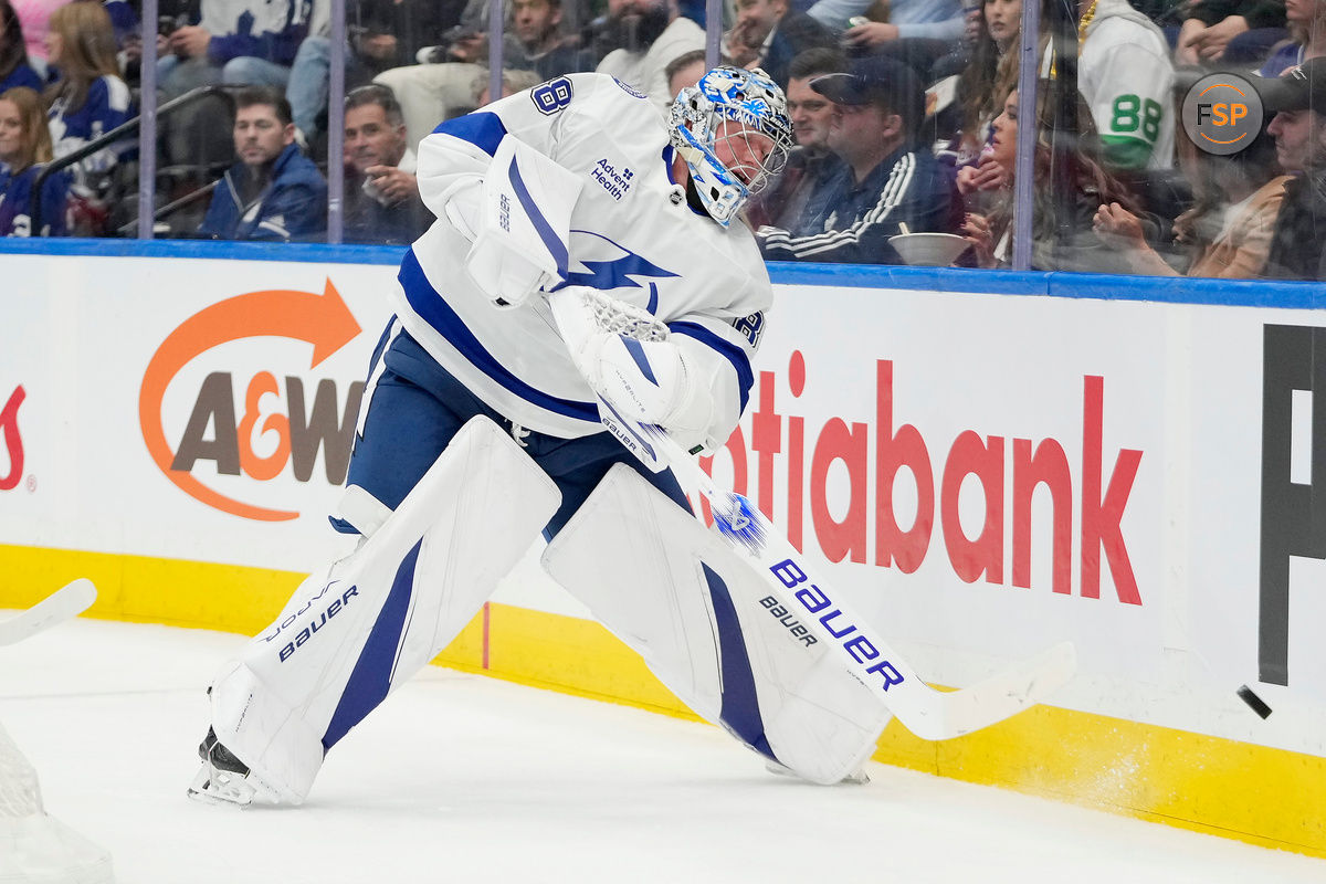 Oct 21, 2024; Toronto, Ontario, CAN; Tampa Bay Lightning goaltender Andrei Vasilevskiy (88) shoots the puck around the boards against the Toronto Maple Leafs  during the first period at Scotiabank Arena. Credit: John E. Sokolowski-Imagn Images