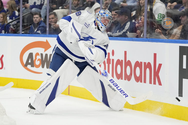 Oct 21, 2024; Toronto, Ontario, CAN; Tampa Bay Lightning goaltender Andrei Vasilevskiy (88) shoots the puck around the boards against the Toronto Maple Leafs  during the first period at Scotiabank Arena. Credit: John E. Sokolowski-Imagn Images