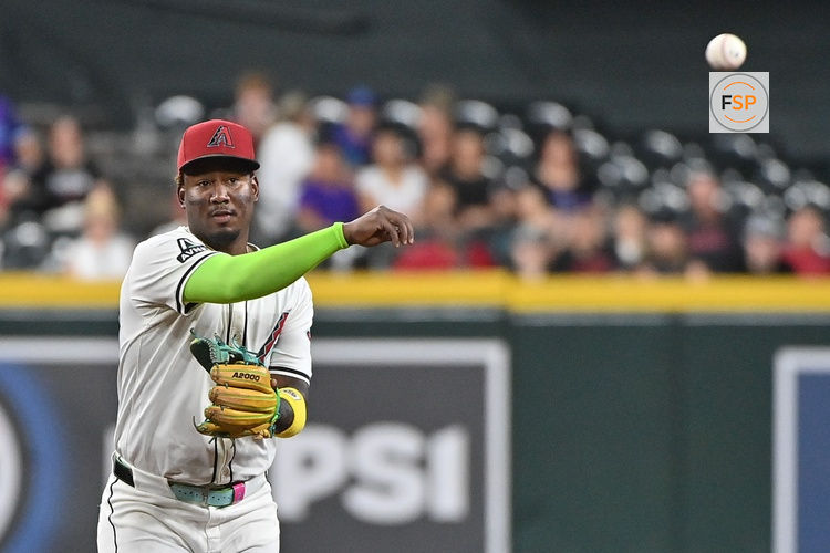Jul 23, 2025; Phoenix, Arizona, USA;  Arizona Diamondbacks shortstop Geraldo Perdomo (2) throw to first base for an out in the first inning against the Houston Astros at Chase Field. Credit: Matt Kartozian-Imagn Images