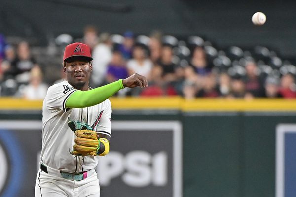 Jul 23, 2025; Phoenix, Arizona, USA;  Arizona Diamondbacks shortstop Geraldo Perdomo (2) throw to first base for an out in the first inning against the Houston Astros at Chase Field. Mandatory Credit: Matt Kartozian-Imagn Images