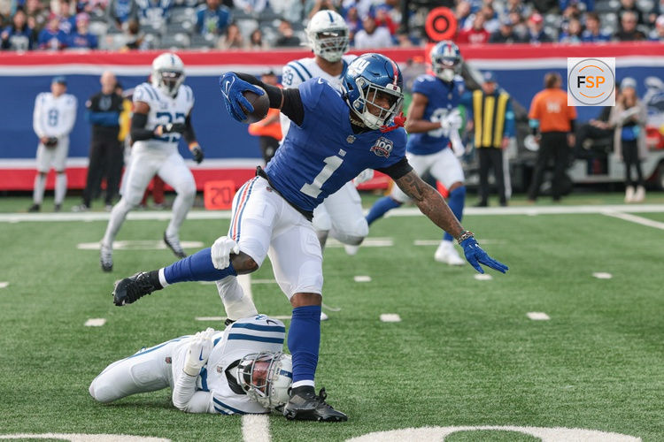 Dec 29, 2024; East Rutherford, New Jersey, USA; New York Giants wide receiver Malik Nabers (1) breaks a tackle by Indianapolis Colts safety Julian Blackmon (32) during a touchdown reception during the first half at MetLife Stadium. Credit: Vincent Carchietta-Imagn Images