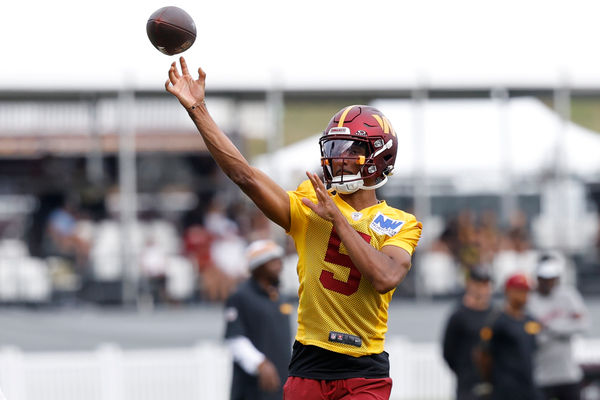 Jul 26, 2024; Ashburn, VA, USA; Washington Commanders quarterback Jayden Daniels (5) passes the ball on day three of training camp at Commanders Park. Mandatory Credit: Geoff Burke-USA TODAY Sports