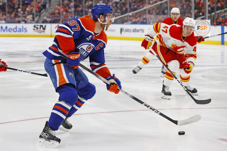 Oct 8, 2025; Edmonton, Alberta, CAN; Edmonton Oilers forward Connor McDavid (97) looks to make a pass in front of Calgary Flames forward Connor Zary (47) during the third period at Rogers Place. Credit: Perry Nelson-Imagn Images