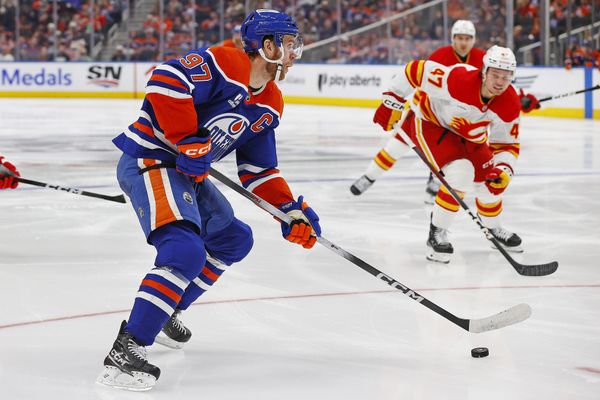 Oct 8, 2025; Edmonton, Alberta, CAN; Edmonton Oilers forward Connor McDavid (97) looks to make a pass in front of Calgary Flames forward Connor Zary (47) during the third period at Rogers Place. Mandatory Credit: Perry Nelson-Imagn Images