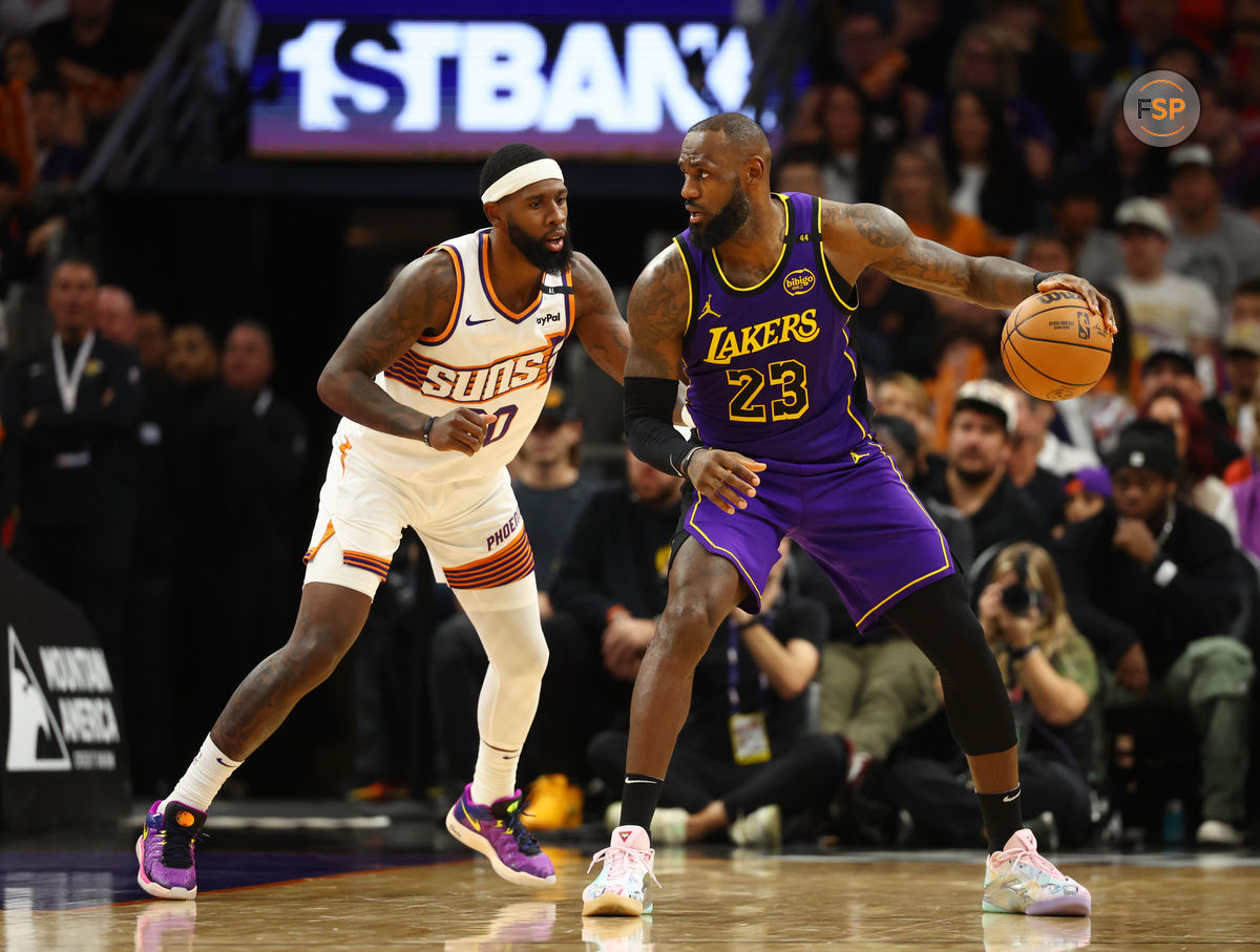 Oct 28, 2024; Phoenix, Arizona, USA; Los Angeles Lakers forward LeBron James (23) against Phoenix Suns forward Royce O'Neale (00) at Footprint Center. Credit: Mark J. Rebilas-Imagn Images