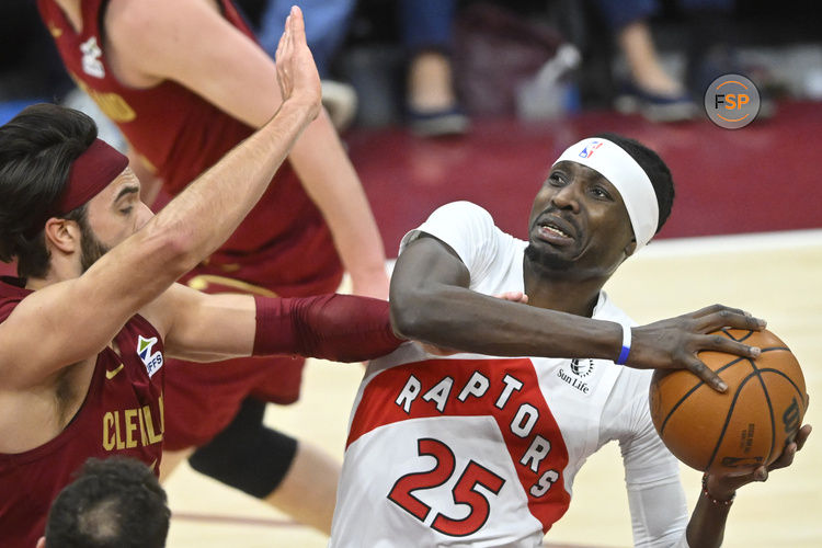 Jan 9, 2025; Cleveland, Ohio, USA; Toronto Raptors forward Chris Boucher (25) looks to the basket beside Cleveland Cavaliers guard Max Strus (1) in the third quarter at Rocket Mortgage FieldHouse. Credit: David Richard-Imagn Images