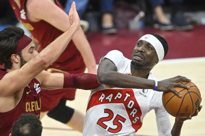 Jan 9, 2025; Cleveland, Ohio, USA; Toronto Raptors forward Chris Boucher (25) looks to the basket beside Cleveland Cavaliers guard Max Strus (1) in the third quarter at Rocket Mortgage FieldHouse. Mandatory Credit: David Richard-Imagn Images