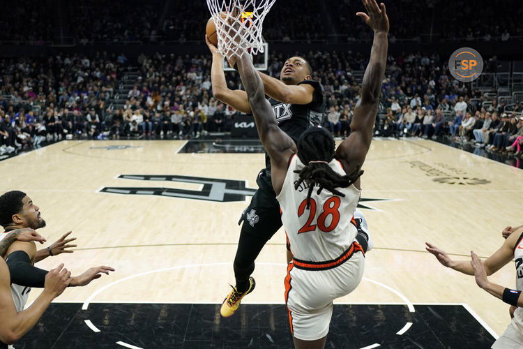 Feb 21, 2025; Austin, Texas, USA; San Antonio Spurs forward Keldon Johnson (0) shoots over Detroit Pistons forward Isaiah Stewart (28) during the first half at Moody Center. Credit: Scott Wachter-Imagn Images