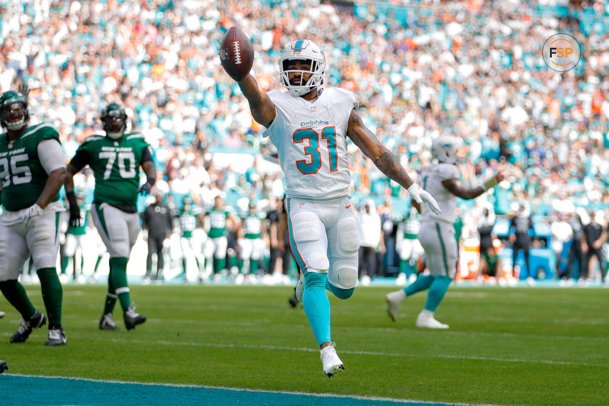 Dec 17, 2023; Miami Gardens, Florida, USA; Miami Dolphins running back Raheem Mostert (31) runs the football for a touchdown against the New York Jets during the first quarter at Hard Rock Stadium. Mandatory Credit: Sam Navarro-USA TODAY Sports