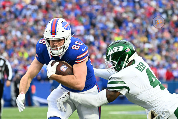 Dec 29, 2024; Orchard Park, New York, USA; Buffalo Bills tight end Dalton Kincaid (86) tries to break free from New York Jets cornerback D.J. Reed (4) after a catch in the first quarter at Highmark Stadium. Credit: Mark Konezny-Imagn Images