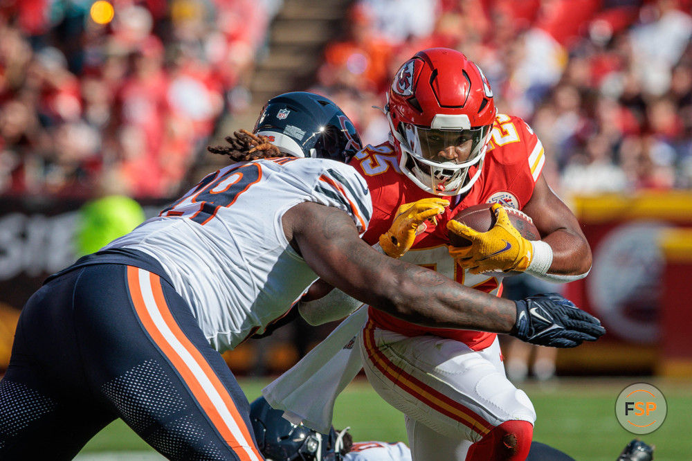 KANSAS CITY, MO - SEPTEMBER 24: Kansas City Chiefs running back Clyde Edwards-Helaire (25) is hit while running the ball during the first half against the Chicago Bears on September 24, 2023 at GEHA Field at Arrowhead Stadium in Kansas City, Missouri. (Photo by William Purnell/Icon Sportswire)
