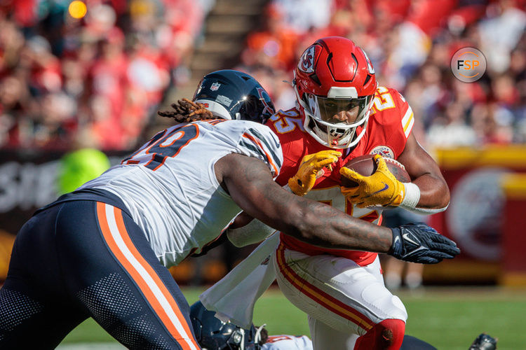 KANSAS CITY, MO - SEPTEMBER 24: Kansas City Chiefs running back Clyde Edwards-Helaire (25) is hit while running the ball during the first half against the Chicago Bears on September 24, 2023 at GEHA Field at Arrowhead Stadium in Kansas City, Missouri. (Photo by William Purnell/Icon Sportswire)