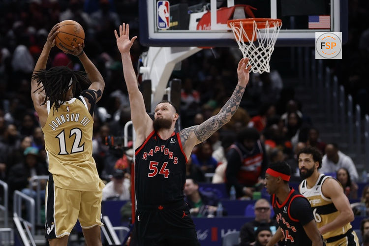 Feb 28, 2026; Washington, District of Columbia, USA; Washington Wizards guard Tre Johnson (12) shoots the ball over Toronto Raptors forward Sandro Mamukelashvili (54) in the second half at Capital One Arena. Credit: Geoff Burke-Imagn Images