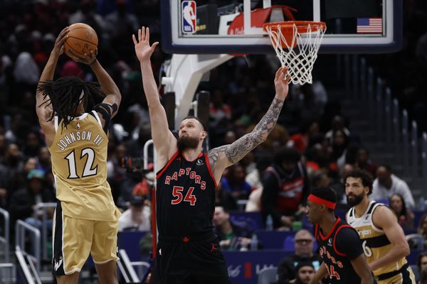 Feb 28, 2026; Washington, District of Columbia, USA; Washington Wizards guard Tre Johnson (12) shoots the ball over Toronto Raptors forward Sandro Mamukelashvili (54) in the second half at Capital One Arena. Mandatory Credit: Geoff Burke-Imagn Images