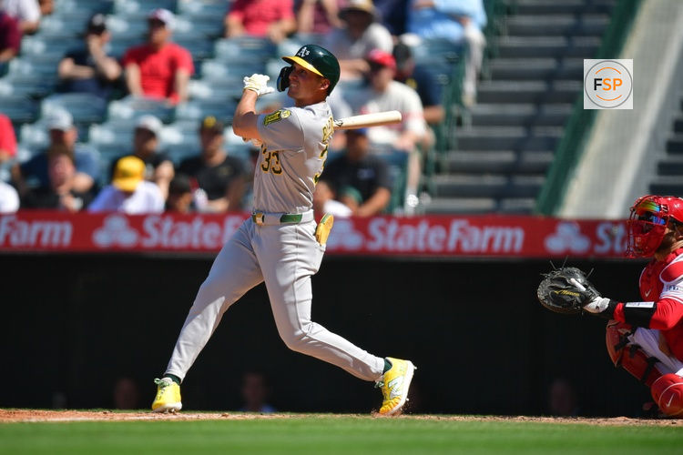 Jun 11, 2025; Anaheim, California, USA; Athletics outfielder JJ Bleday (33) hits a double against the Los Angeles Angels during the eighth inning at Angel Stadium. Credit: Gary A. Vasquez-Imagn Images