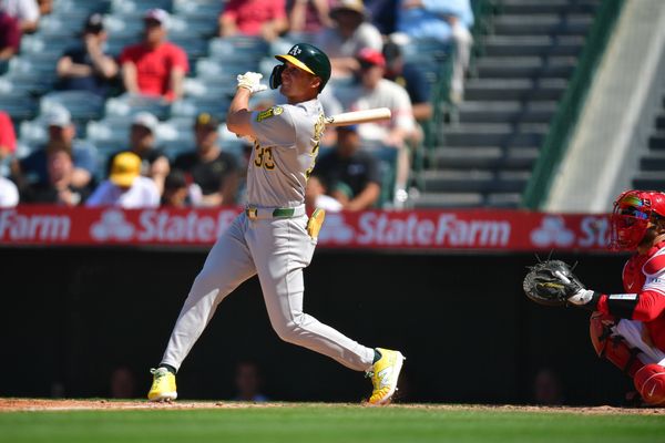 Jun 11, 2025; Anaheim, California, USA; Athletics outfielder JJ Bleday (33) hits a double against the Los Angeles Angels during the eighth inning at Angel Stadium. Mandatory Credit: Gary A. Vasquez-Imagn Images
