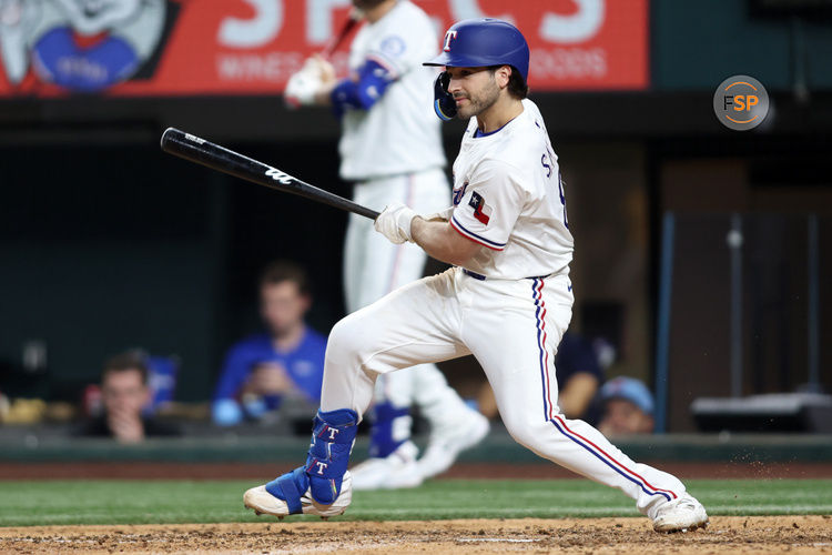 Apr 29, 2025; Arlington, Texas, USA; Texas Rangers shortstop Josh Smith (8) singles in a run during the eighth inning against the Oakland Athletics at Globe Life Field. Credit: Tim Heitman-Imagn Images