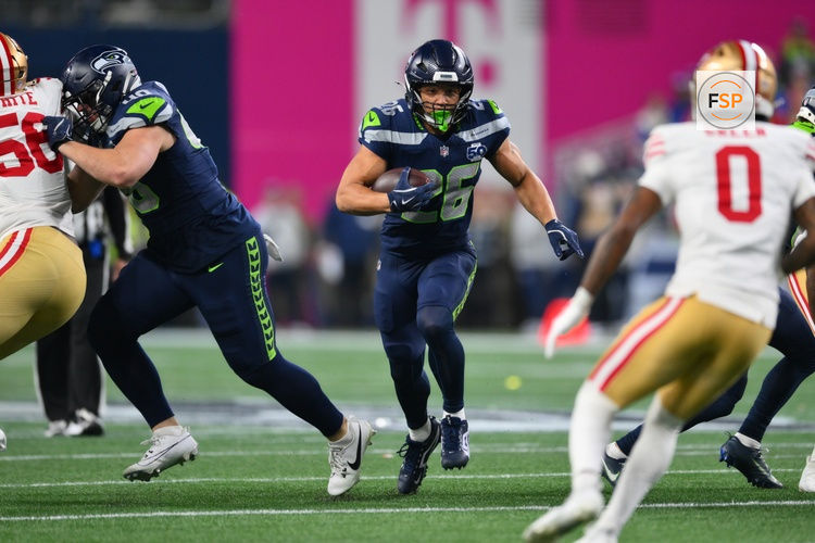 Jan 17, 2026; Seattle, WA, USA; Seattle Seahawks running back Zach Charbonnet (26) carries the ball against the San Francisco 49ers during the first half in an NFC Divisional Round game at Lumen Field. Credit: Steven Bisig-Imagn Images