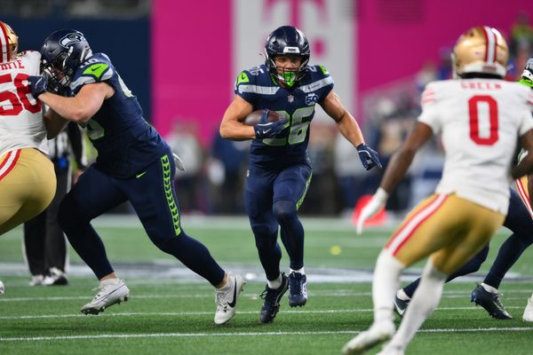 Jan 17, 2026; Seattle, WA, USA; Seattle Seahawks running back Zach Charbonnet (26) carries the ball against the San Francisco 49ers during the first half in an NFC Divisional Round game at Lumen Field. Mandatory Credit: Steven Bisig-Imagn Images