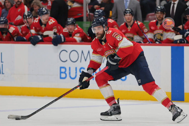 Mar 3, 2025; Sunrise, Florida, USA; Florida Panthers defenseman Aaron Ekblad (5) moves the puck against the Tampa Bay Lightning during the second period at Amerant Bank Arena. Credit: Sam Navarro-Imagn Images