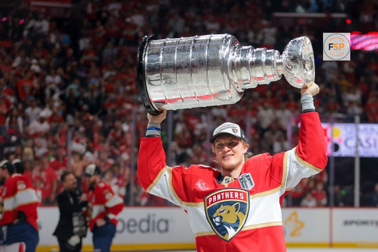 Jun 17, 2025; Sunrise, Florida, USA; Florida Panthers center Anton Lundell (15) hoists the Stanley Cup after winning game six of the 2025 Stanley Cup Final against the Edmonton Oilers at Amerant Bank Arena. Credit: Sam Navarro-Imagn Images