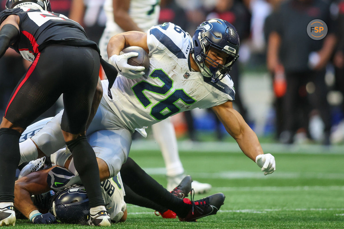 Oct 20, 2024; Atlanta, Georgia, USA; Seattle Seahawks running back Zach Charbonnet (26) runs the ball against the Atlanta Falcons in the third quarter at Mercedes-Benz Stadium. Credit: Brett Davis-Imagn Images