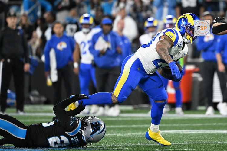 Jan 10, 2026; Charlotte, NC, USA; Los Angeles Rams running back Kyren Williams (23) rushes the ball against Carolina Panthers linebacker Christian Rozeboom (56) in the second half during the NFC Wild Card Round game at Bank of America Stadium. Credit: Bob Donnan-Imagn Images