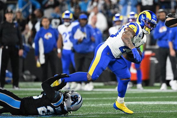 Jan 10, 2026; Charlotte, NC, USA; Los Angeles Rams running back Kyren Williams (23) rushes the ball against Carolina Panthers linebacker Christian Rozeboom (56) in the second half during the NFC Wild Card Round game at Bank of America Stadium. Mandatory Credit: Bob Donnan-Imagn Images