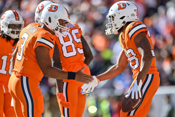 DENVER, CO - OCTOBER 8: Denver Broncos running back Jaleel McLaughlin (38) celebrates with quarterback Russell Wilson (3) after scoring a first quarter touchdown during a game between the New York Jets and the Denver Broncos at Empower Field at Mile High on October 8, 2023 in Denver, Colorado. (Photo by Dustin Bradford/Icon Sportswire)