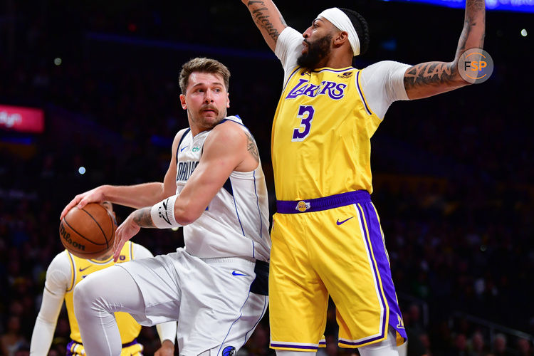 Nov 22, 2023; Los Angeles, California, USA; Dallas Mavericks guard Luka Doncic (77) passes the ball against Los Angeles Lakers forward Anthony Davis (3) during the first half at Crypto.com Arena. Credit: Gary A. Vasquez-USA TODAY Sports