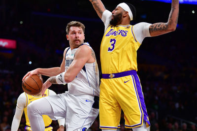 Nov 22, 2023; Los Angeles, California, USA; Dallas Mavericks guard Luka Doncic (77) passes the ball against Los Angeles Lakers forward Anthony Davis (3) during the first half at Crypto.com Arena. Mandatory Credit: Gary A. Vasquez-USA TODAY Sports