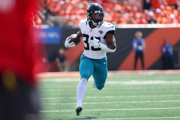 Sep 14, 2025; Cincinnati, Ohio, USA;  Jacksonville Jaguars running back Bhayshul Tuten (33) runs the ball during the first quarter against the Cincinnati Bengals at Paycor Stadium. Mandatory Credit: Joseph Maiorana-Imagn Images