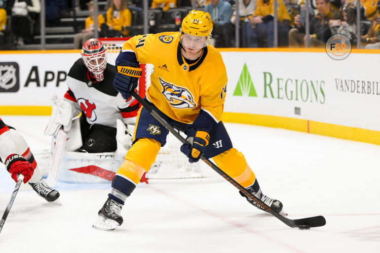 Feb 23, 2025; Nashville, Tennessee, USA;  Nashville Predators center Gustav Nyquist (14) skates with the puck against the New Jersey Devils during the third half at Bridgestone Arena. Credit: Steve Roberts-Imagn Images