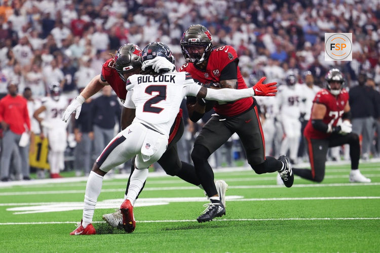Sep 15, 2025; Houston, Texas, USA; Tampa Bay Buccaneers wide receiver Emeka Egbuka (2) runs for a touchdown as Houston Texans safety Calen Bullock (2) defends during the second quarter at NRG Stadium. Credit: Troy Taormina-Imagn Images