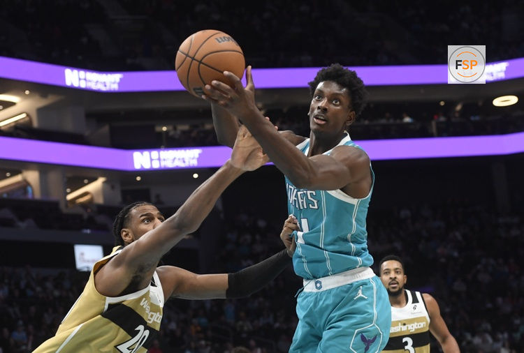 Dec 23, 2025; Charlotte, North Carolina, USA;  Charlotte Hornets center Moussa Diabate (14) and Washington Wizards forward Alex Sarr (20) go after a rebound during the second half at the Spectrum Center. Credit: Sam Sharpe-Imagn Images