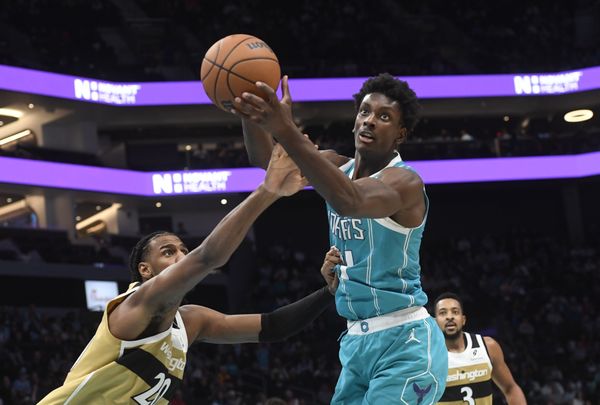 Dec 23, 2025; Charlotte, North Carolina, USA;  Charlotte Hornets center Moussa Diabate (14) and Washington Wizards forward Alex Sarr (20) go after a rebound during the second half at the Spectrum Center. Mandatory Credit: Sam Sharpe-Imagn Images