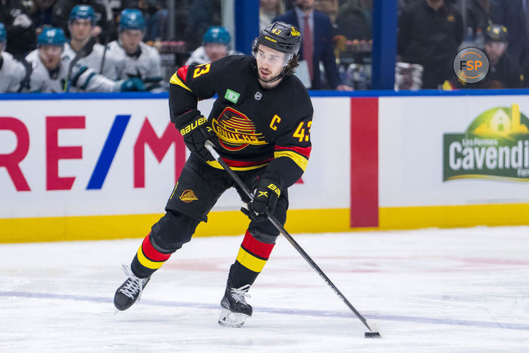 Dec 23, 2024; Vancouver, British Columbia, CAN; Vancouver Canucks defenseman Quinn Hughes (43) handles the puck against the San Jose Sharks during the first period at Rogers Arena. Credit: Bob Frid-Imagn Images