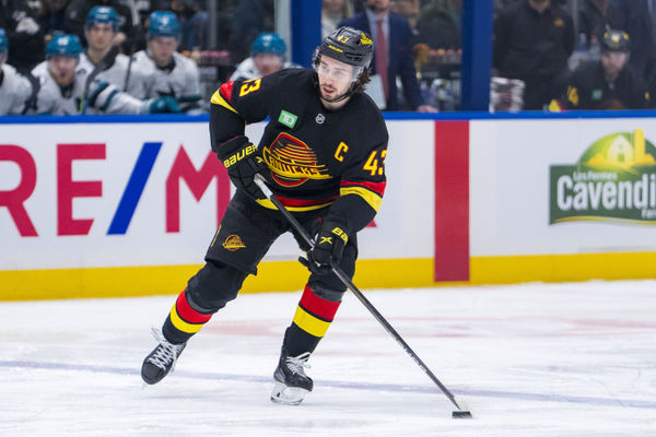 Dec 23, 2024; Vancouver, British Columbia, CAN; Vancouver Canucks defenseman Quinn Hughes (43) handles the puck against the San Jose Sharks during the first period at Rogers Arena. Mandatory Credit: Bob Frid-Imagn Images