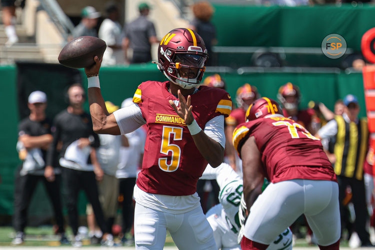 Aug 10, 2024; East Rutherford, New Jersey, USA; Washington Commanders quarterback Jayden Daniels (5) throws the ball during the first quarter against the New York Jets at MetLife Stadium. Credit: Vincent Carchietta-USA TODAY Sports