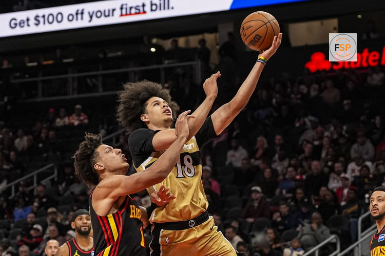 Feb 24, 2026; Atlanta, Georgia, USA; Washington Wizards forward Kyshawn George (18) goes to the basket over Atlanta Hawks forward Jalen Johnson (1) during the first half at State Farm Arena. Credit: Dale Zanine-Imagn Images