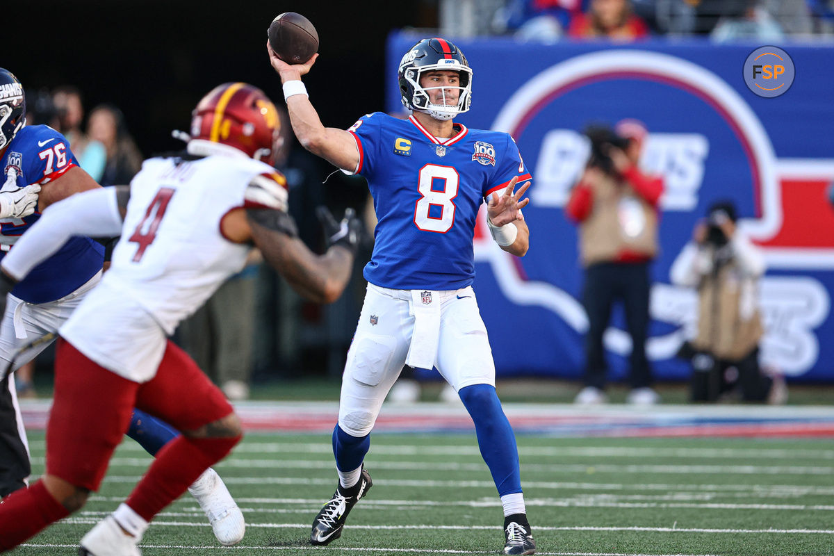 Nov 3, 2024; East Rutherford, New Jersey, USA; New York Giants quarterback Daniel Jones (8) throws the ball as Washington Commanders linebacker Frankie Luvu (4) defends during the second half at MetLife Stadium. Credit: Vincent Carchietta-Imagn Images